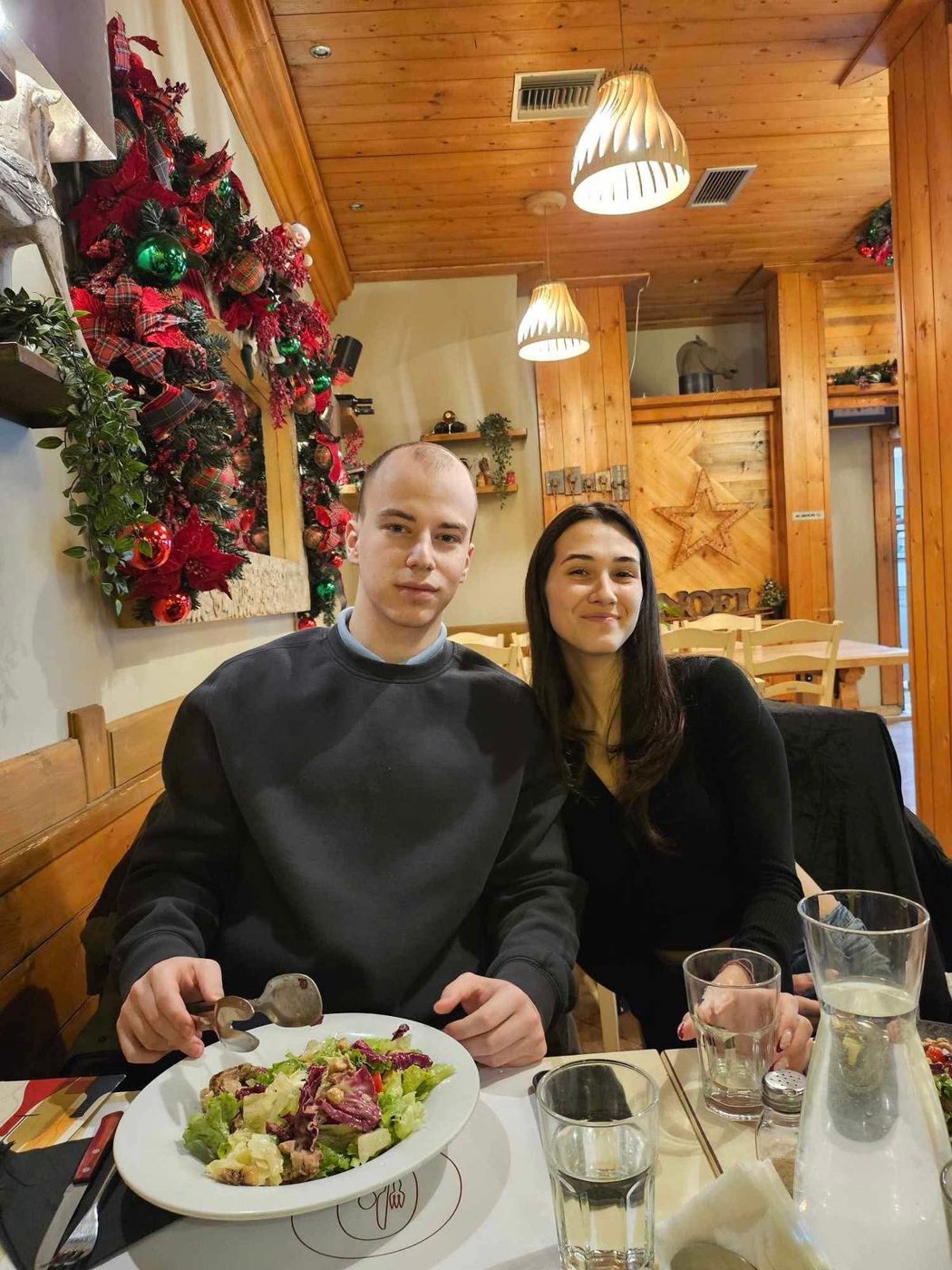 Us at a restaurant decorated for Christmas