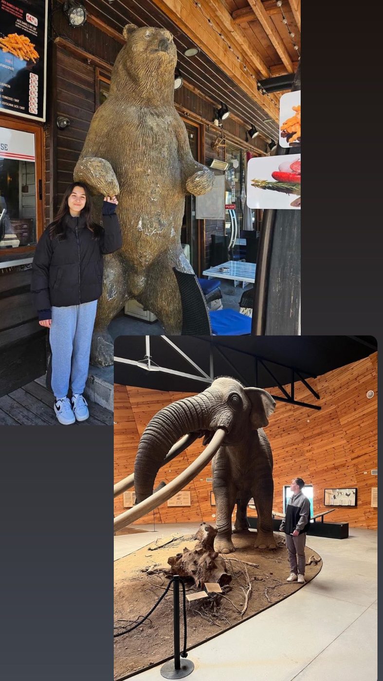 Viktoria next to a bear statue and Venci next to a mammoth
